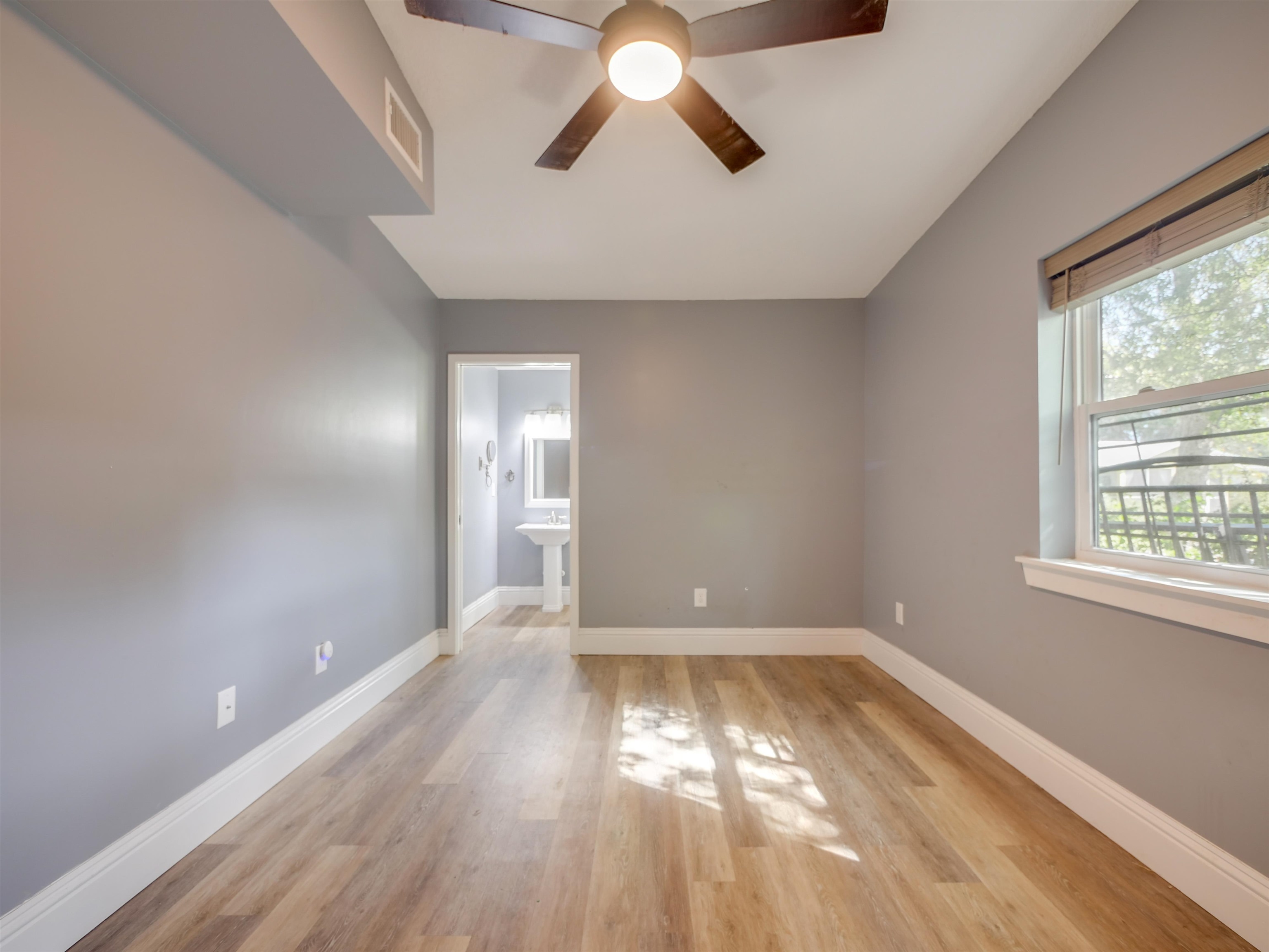262 Spring Street St. Augustine, FL 32084 - Photo 20 of 25 wooden floor in an empty room with a window