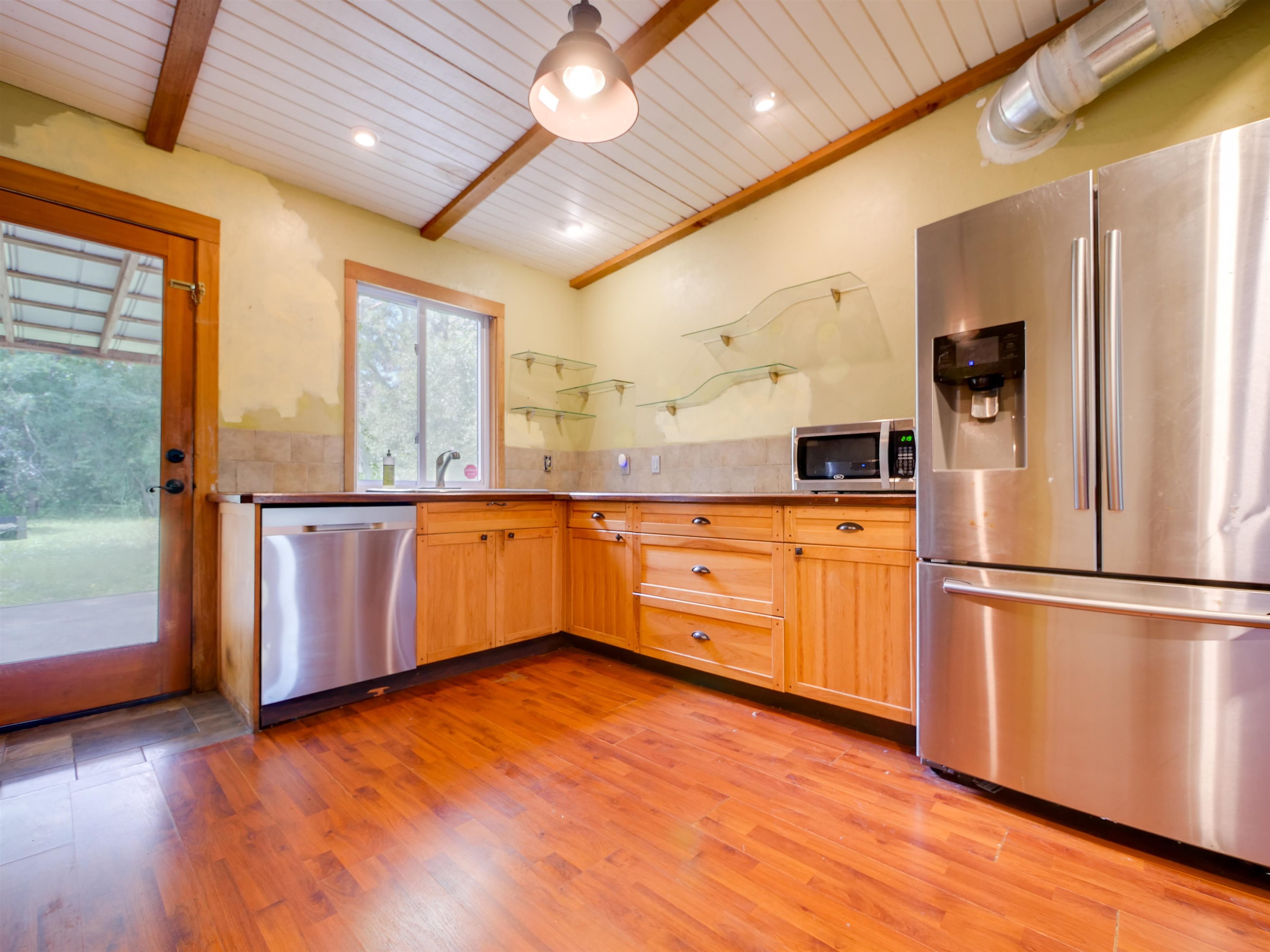 262 Spring Street St. Augustine, FL 32084 - Photo 8 of 25 a kitchen with stainless steel appliances granite countertop a refrigerator a sink and a stove