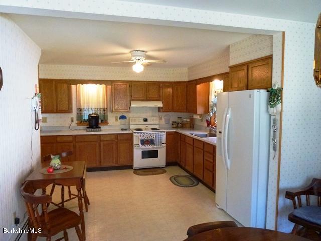 457 Horrigan Road Clarksburg, MA 01247 - Photo 11 of 32 a kitchen with a refrigerator a sink and cabinets