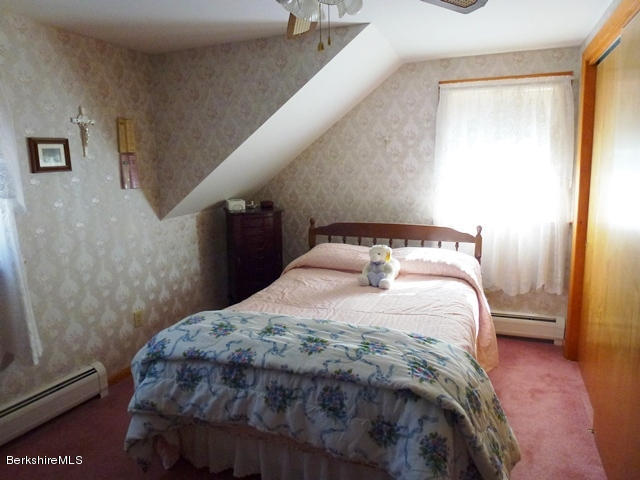 457 Horrigan Road Clarksburg, MA 01247 - Photo 16 of 32 a bedroom with a bed and wooden floor