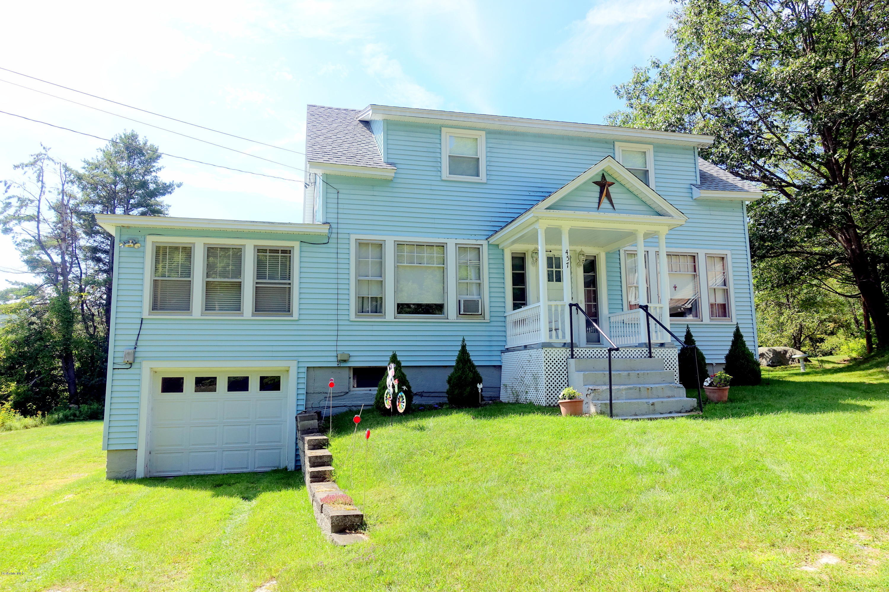457 Horrigan Road Clarksburg, MA 01247 - Photo 5 of 32 a front view of a house with a garden and trees