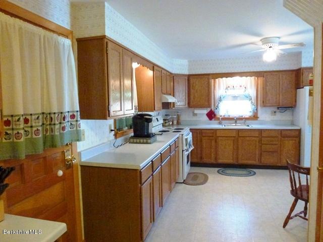 457 Horrigan Road Clarksburg, MA 01247 - Photo 10 of 32 a kitchen with a sink stove and cabinets