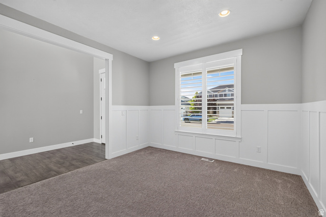 36 West Syracuse Road Vineyard, UT 84059 - Photo 9 of 56 Bright interior space featuring a window with plantation shutters, recessed lighting, and wainscoting