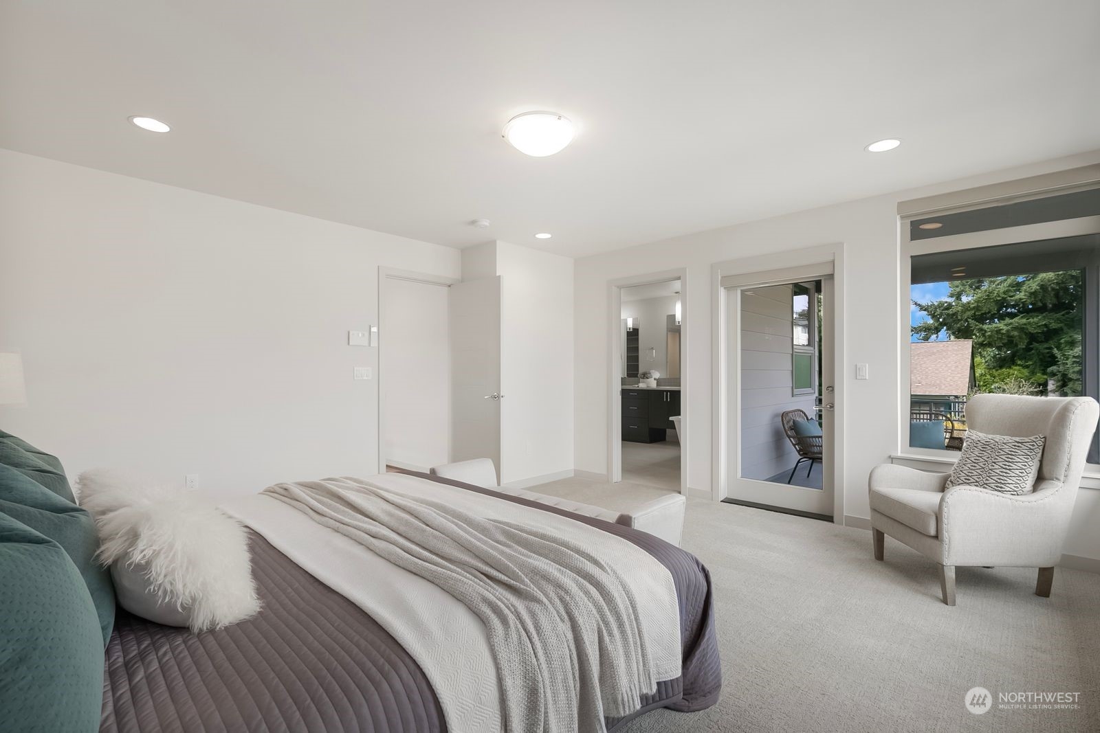 2832 Northwest 65th Street Seattle, WA 98117 - Photo 17 of 38 a spacious bedroom with a bed and glass window