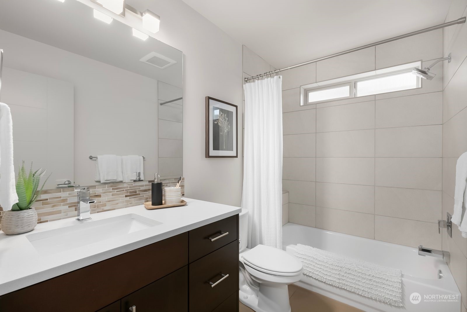 2832 Northwest 65th Street Seattle, WA 98117 - Photo 23 of 38 a bathroom with a sink a toilet and shower