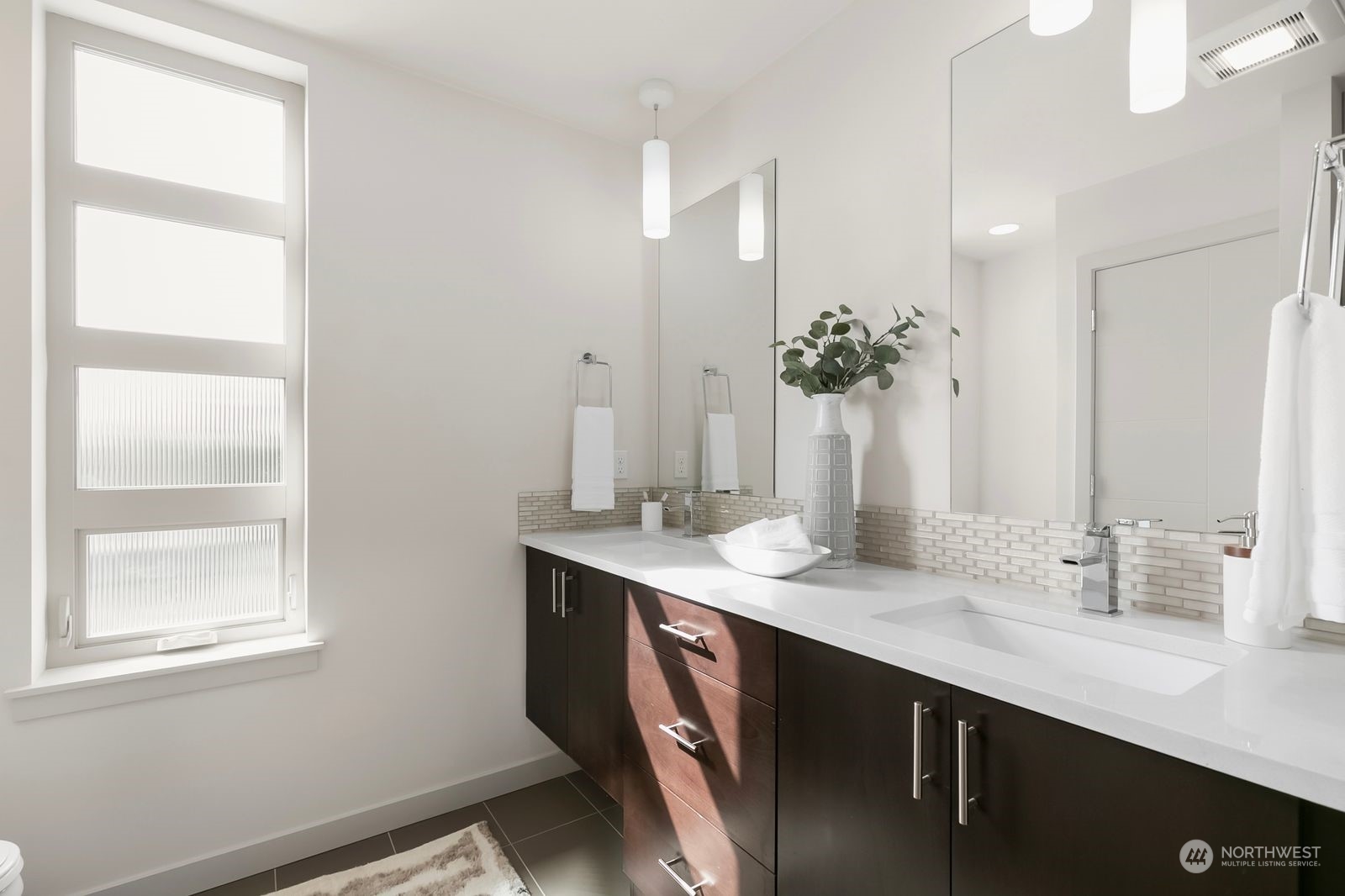 2832 Northwest 65th Street Seattle, WA 98117 - Photo 24 of 38 a bathroom with a sink double vanity and a mirror