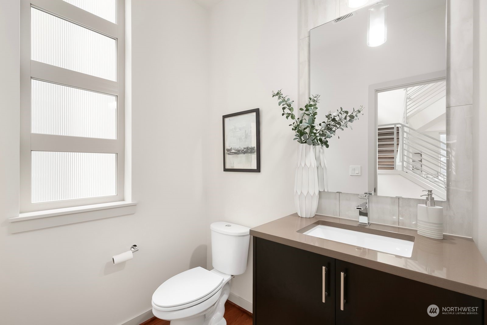 2832 Northwest 65th Street Seattle, WA 98117 - Photo 29 of 38 a bathroom with a granite countertop sink toilet a large mirror and a window