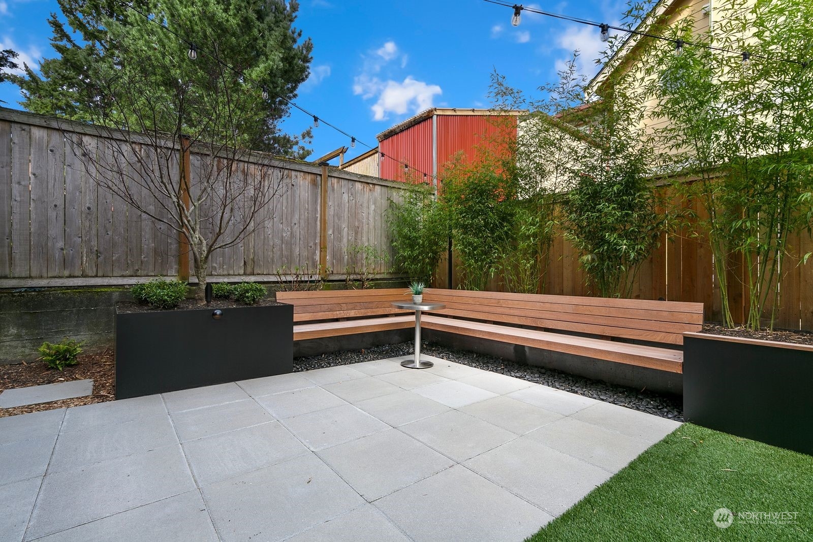 2832 Northwest 65th Street Seattle, WA 98117 - Photo 38 of 38 a backyard of a house with a bench and wooden fence