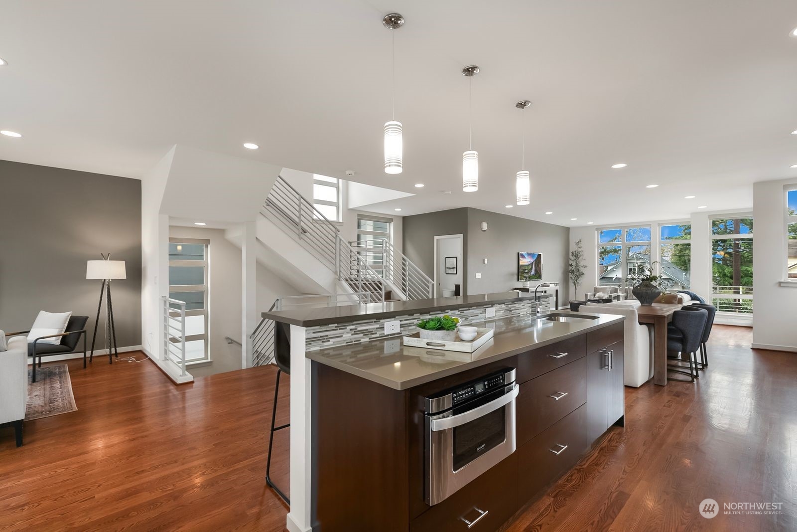 2832 Northwest 65th Street Seattle, WA 98117 - Photo 4 of 38 a kitchen with stainless steel appliances granite countertop a lot of counter space and wooden floor