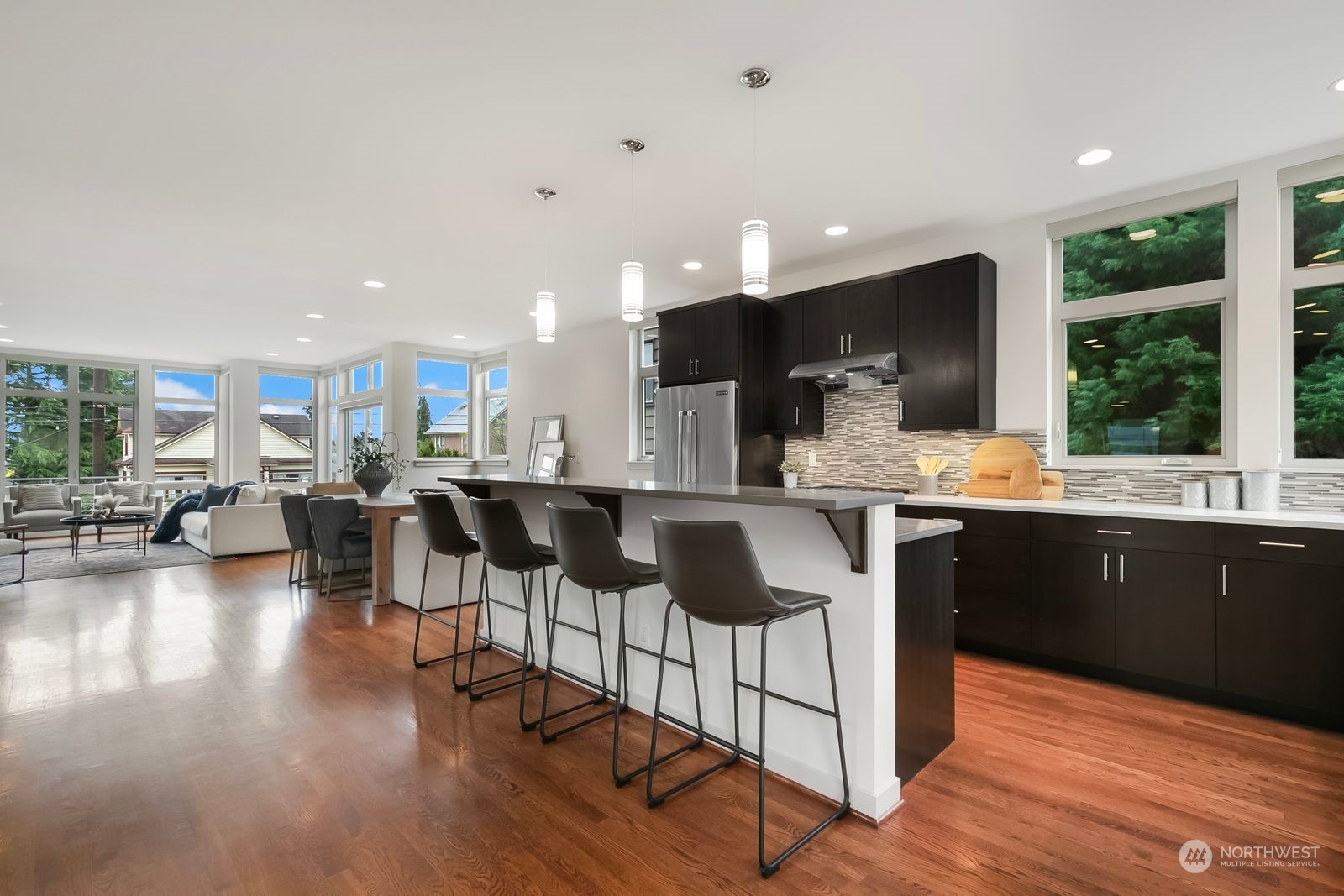 2832 Northwest 65th Street Seattle, WA 98117 - Photo 8 of 38 a kitchen with stainless steel appliances kitchen island granite countertop a stove a sink and a refrigerator