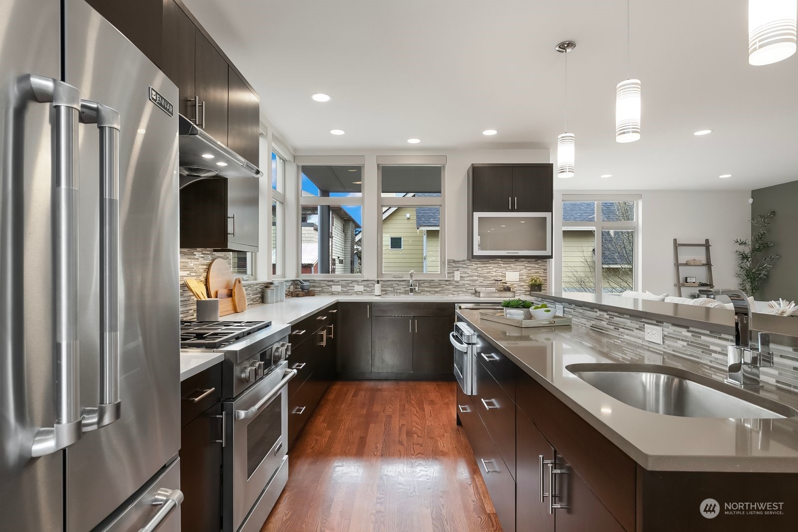 2832 Northwest 65th Street Seattle, WA 98117 - Photo 10 of 38 a kitchen with stainless steel appliances granite countertop a sink a stove and a refrigerator