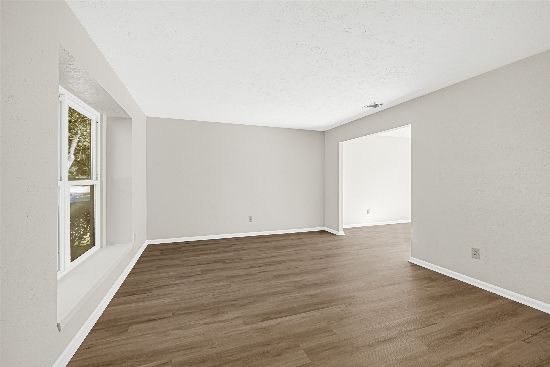 10210 Crooks Way Court Houston, TX 77065 - Photo 11 of 50 a view of an empty room with wooden floor and a window