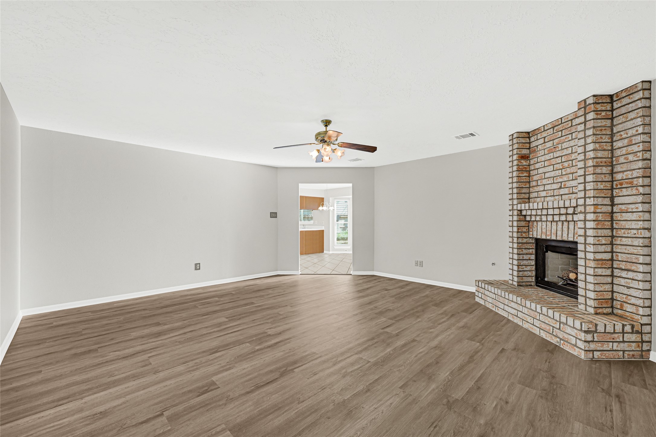 10210 Crooks Way Court Houston, TX 77065 - Photo 14 of 50 a view of an empty room with wooden floor and a fireplace