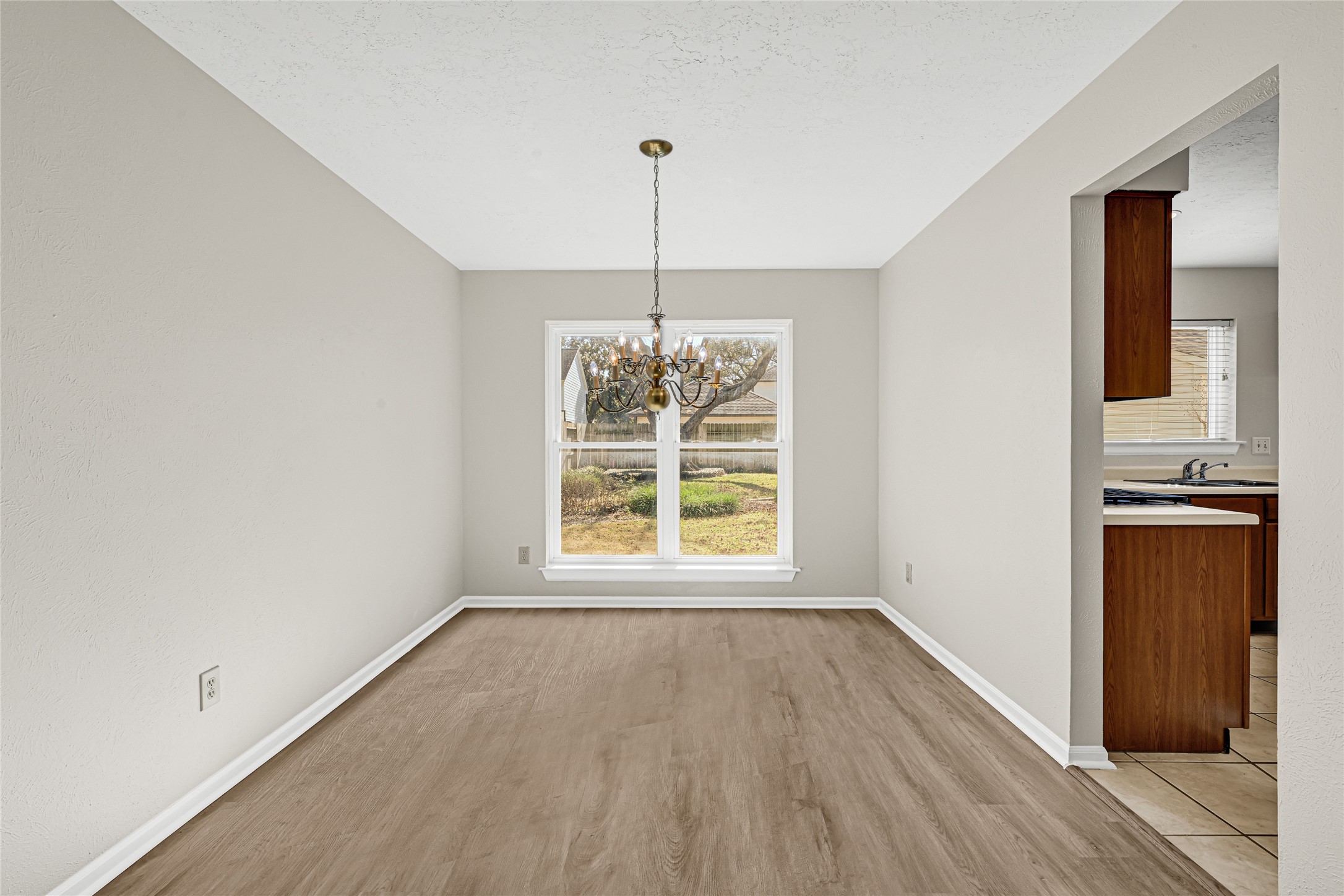 10210 Crooks Way Court Houston, TX 77065 - Photo 16 of 50 a view of an empty room with window and wooden floor