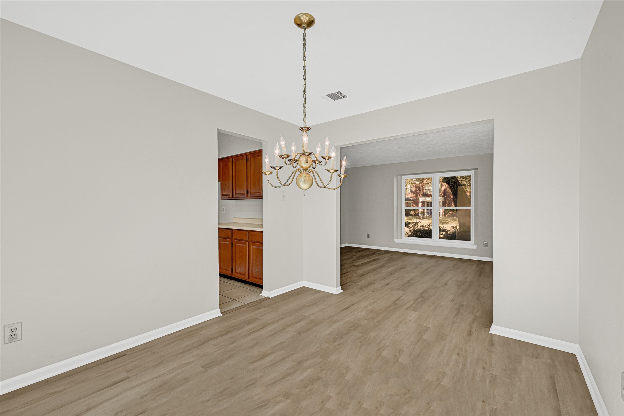 10210 Crooks Way Court Houston, TX 77065 - Photo 17 of 50 a view of an empty room with window and wooden floor