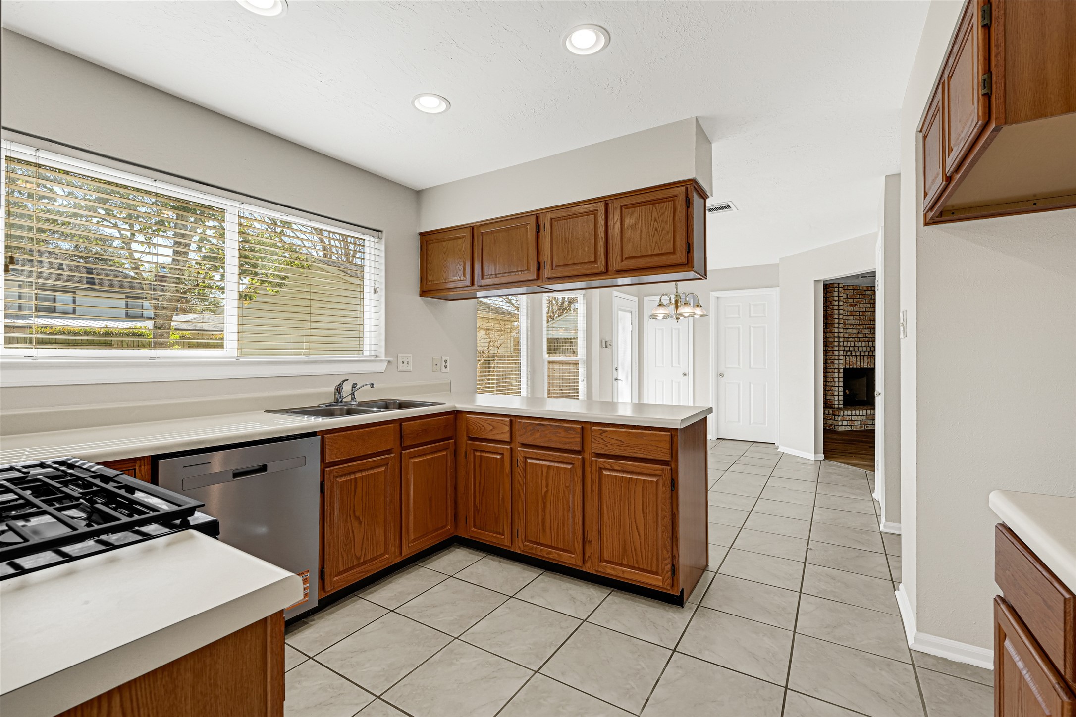 10210 Crooks Way Court Houston, TX 77065 - Photo 18 of 50 a kitchen with stainless steel appliances a sink stove and cabinets