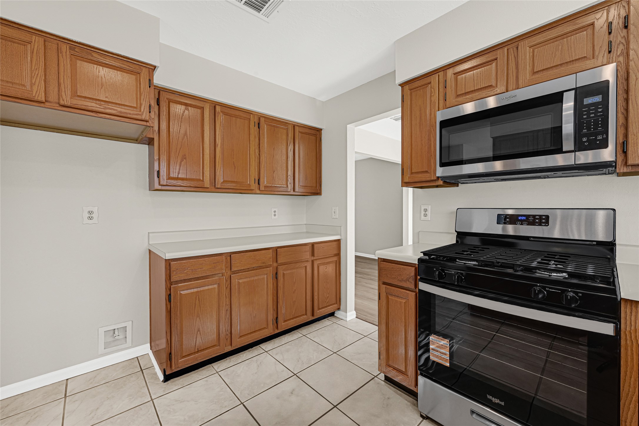 10210 Crooks Way Court Houston, TX 77065 - Photo 19 of 50 a kitchen with stainless steel appliances a stove microwave and cabinets