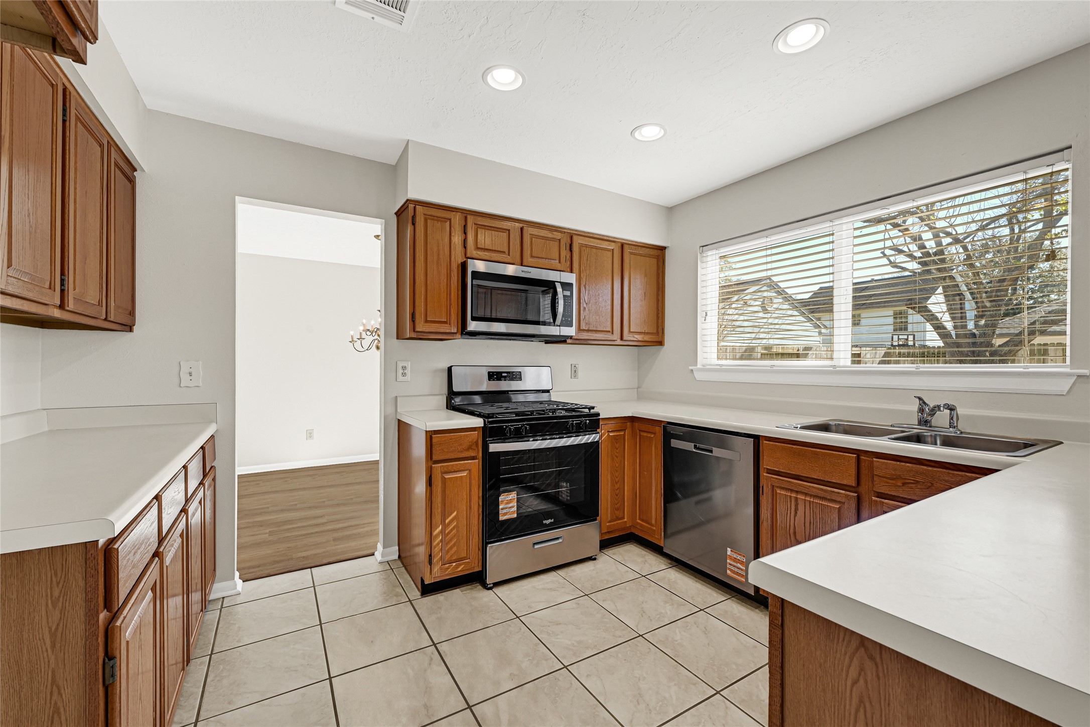 10210 Crooks Way Court Houston, TX 77065 - Photo 2 of 50 a kitchen with stainless steel appliances granite countertop a stove a sink and a microwave