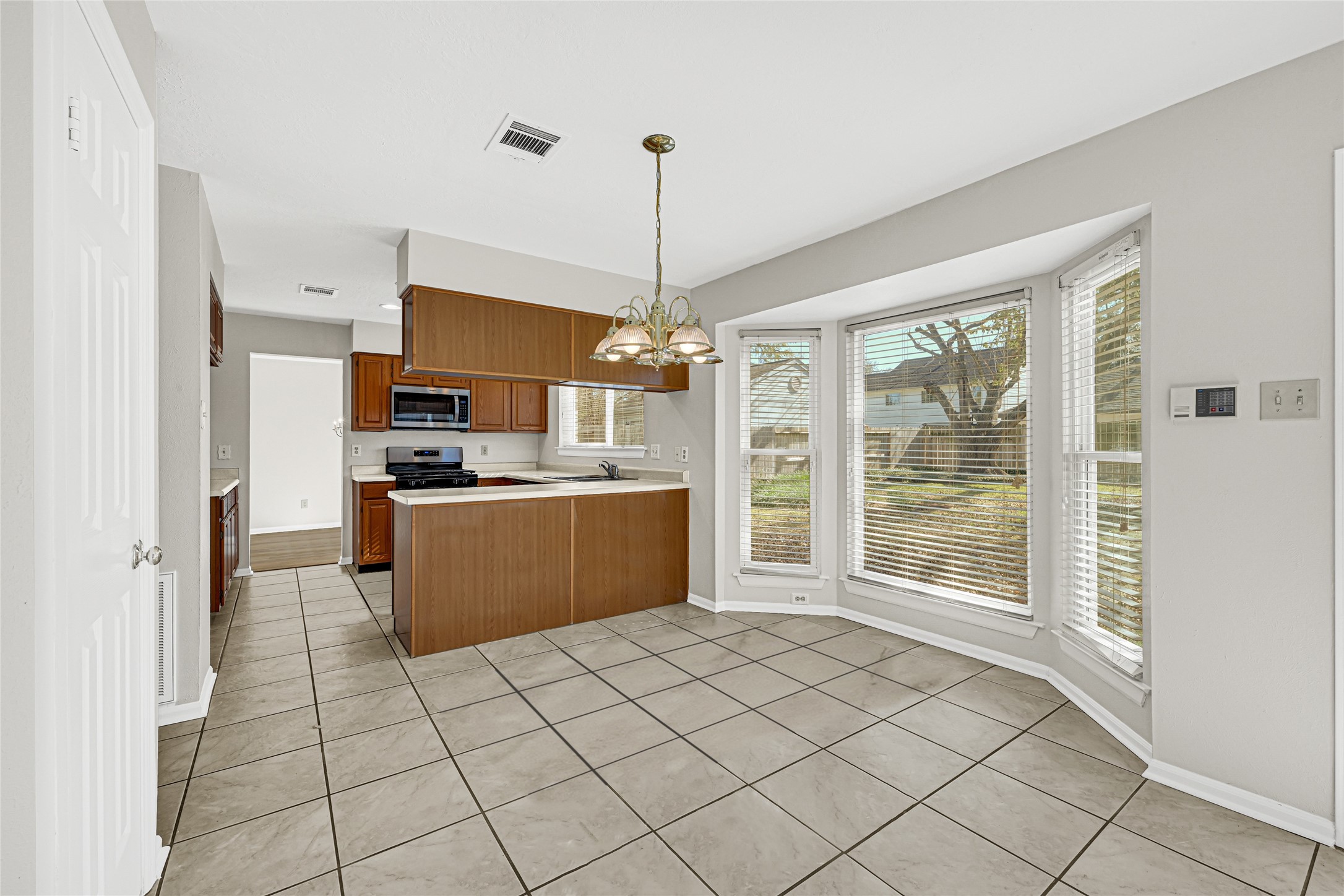 10210 Crooks Way Court Houston, TX 77065 - Photo 4 of 50 a kitchen with stainless steel appliances kitchen island granite countertop a refrigerator a stove a sink dishwasher with a barbeque oven and cabinets
