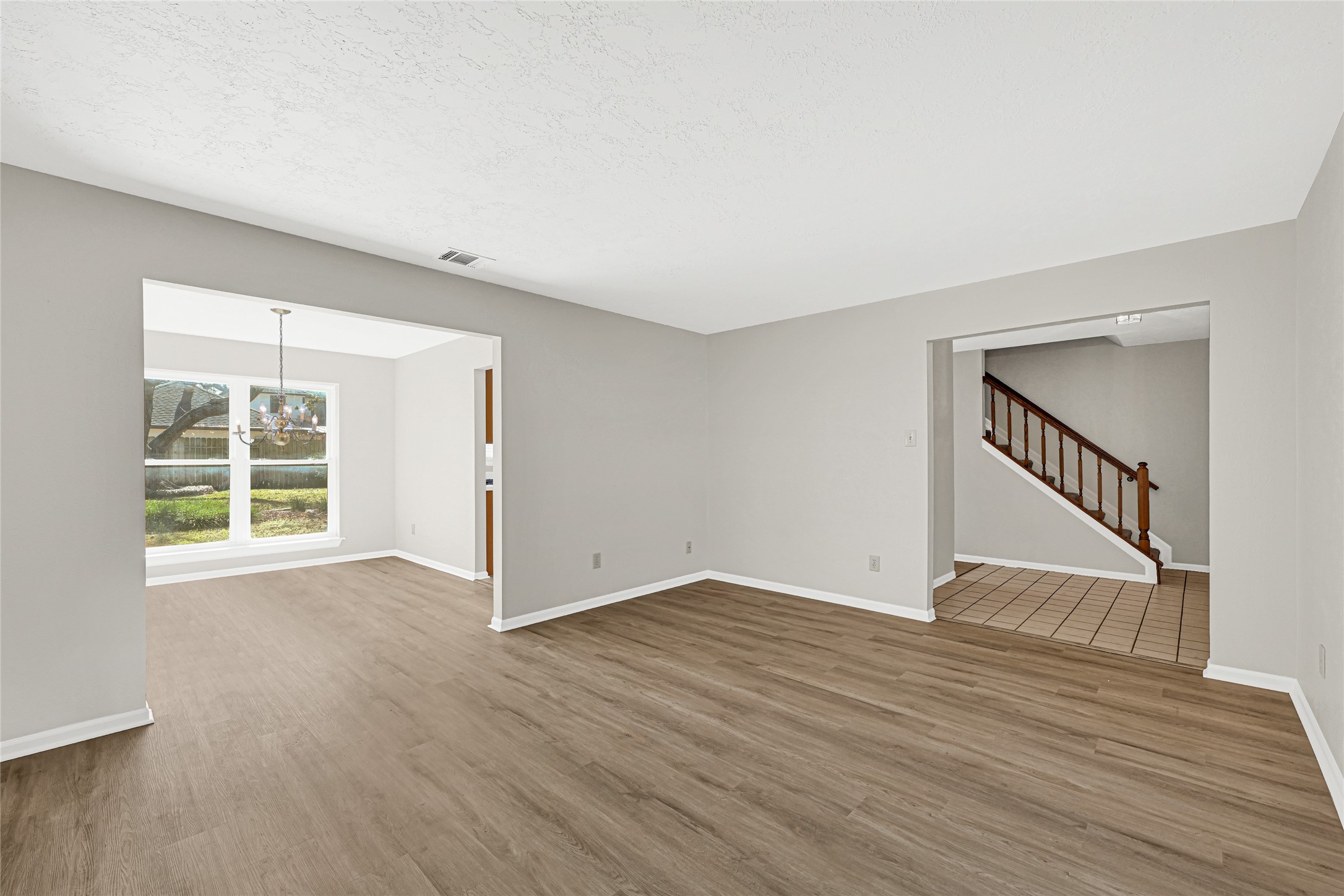 10210 Crooks Way Court Houston, TX 77065 - Photo 10 of 50 a view of an empty room with wooden floor and a window