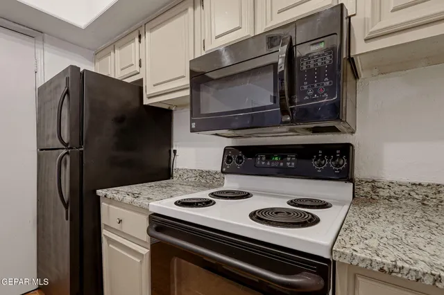 a stove top oven sitting inside of a kitchen