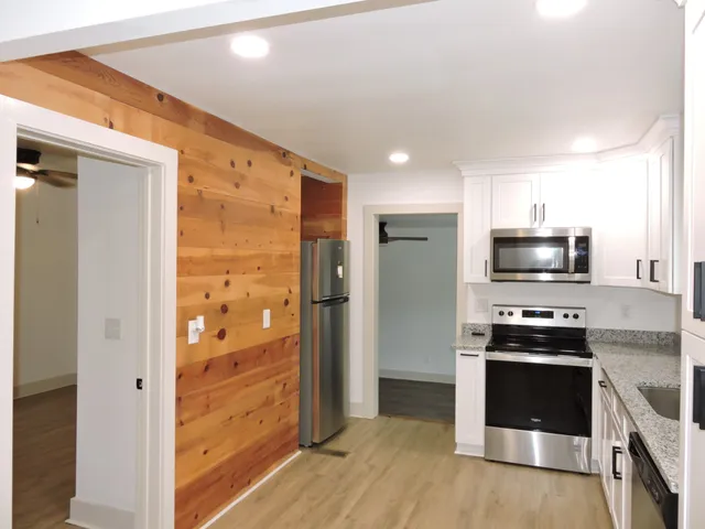 a kitchen with stainless steel appliances granite countertop a stove and a refrigerator