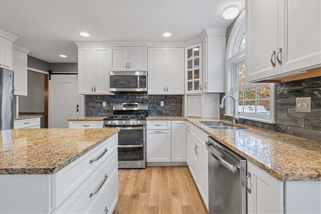 Undisclosed Address Gibsonia, PA 15044 - Photo 11 of 35 a kitchen with stainless steel appliances granite countertop a sink stove microwave and cabinets