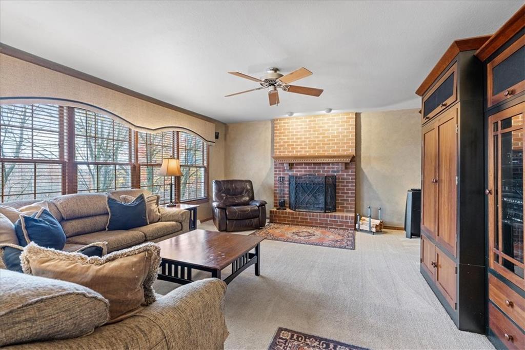 Undisclosed Address Gibsonia, PA 15044 - Photo 13 of 35 a living room with furniture a fireplace and a flat screen tv