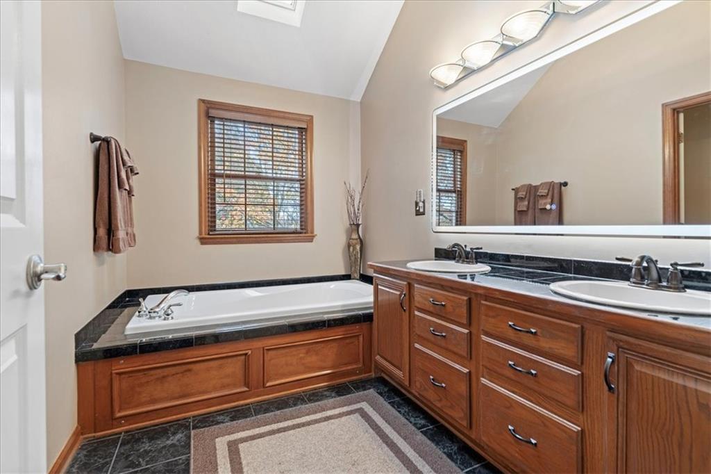 Undisclosed Address Gibsonia, PA 15044 - Photo 18 of 35 a spacious bathroom with a granite countertop double vanity sink a mirror and a bathtub