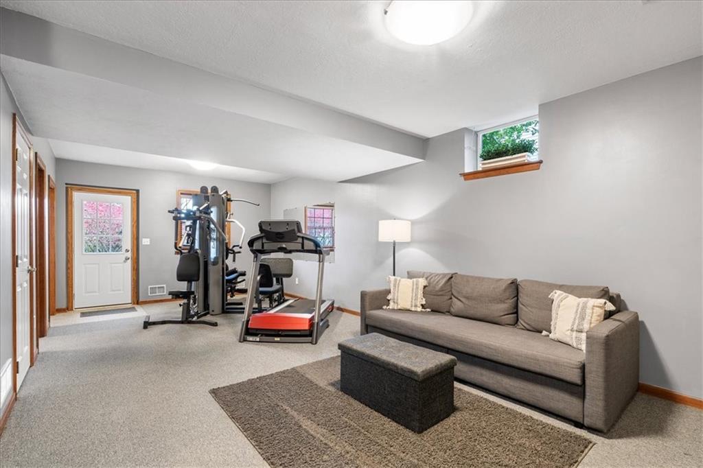Undisclosed Address Gibsonia, PA 15044 - Photo 25 of 35 a living room with furniture a gym equipment and a window