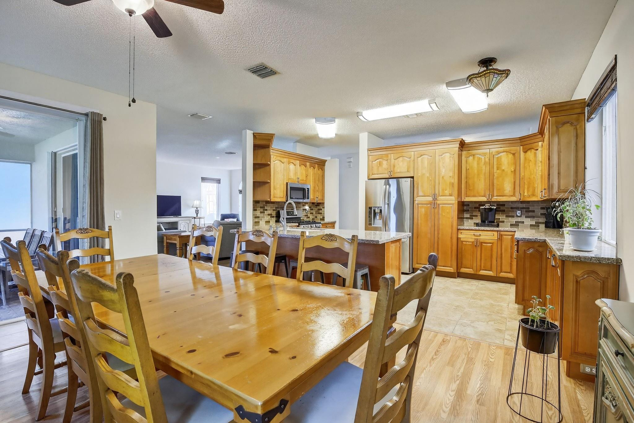 19427 Southwest 65th Street Fort Lauderdale, FL 33332 - Photo 16 of 56 a living room with stainless steel appliances kitchen island granite countertop furniture and a large window