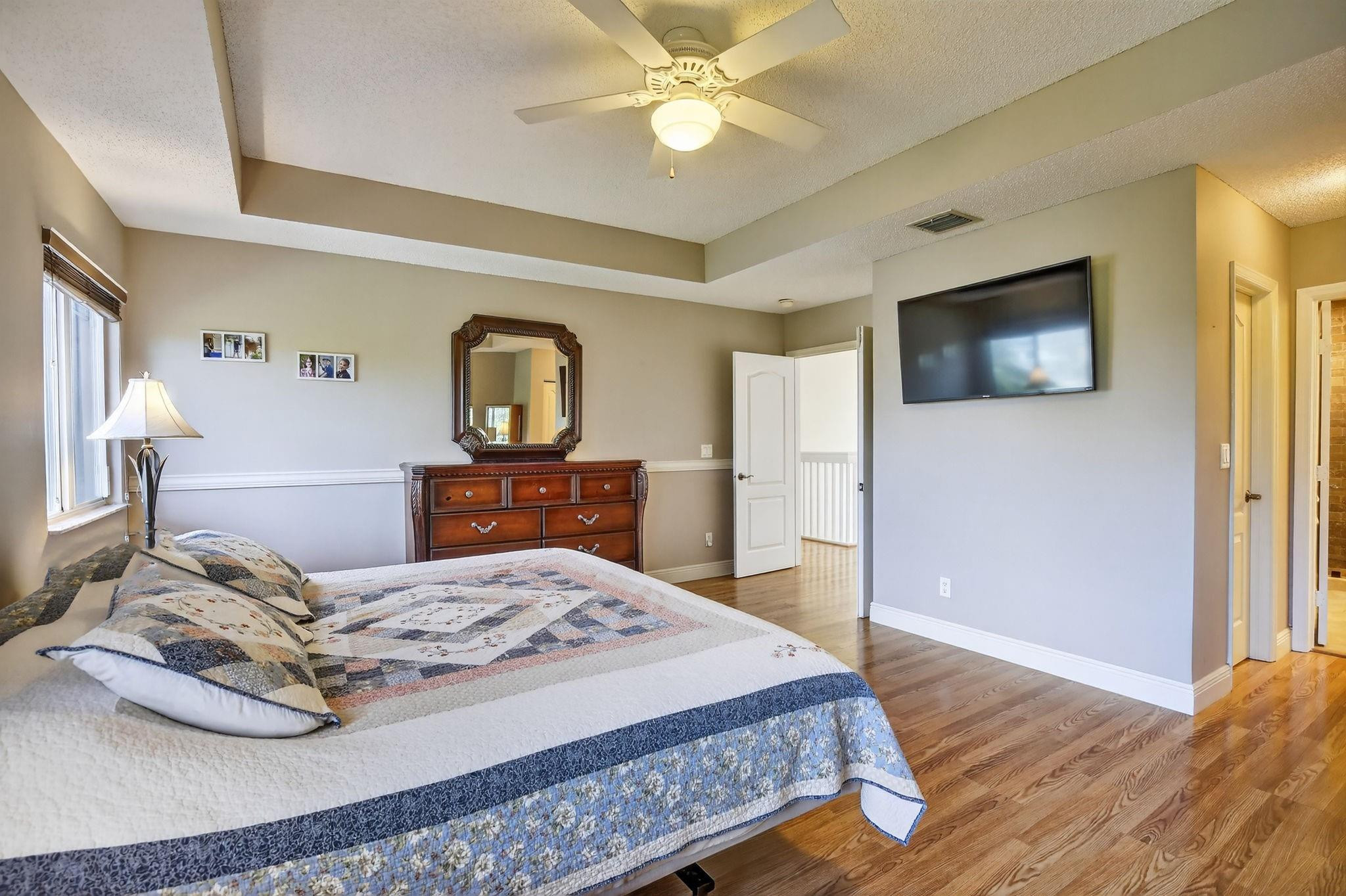 19427 Southwest 65th Street Fort Lauderdale, FL 33332 - Photo 21 of 56 a bedroom with a bed and a flat screen tv