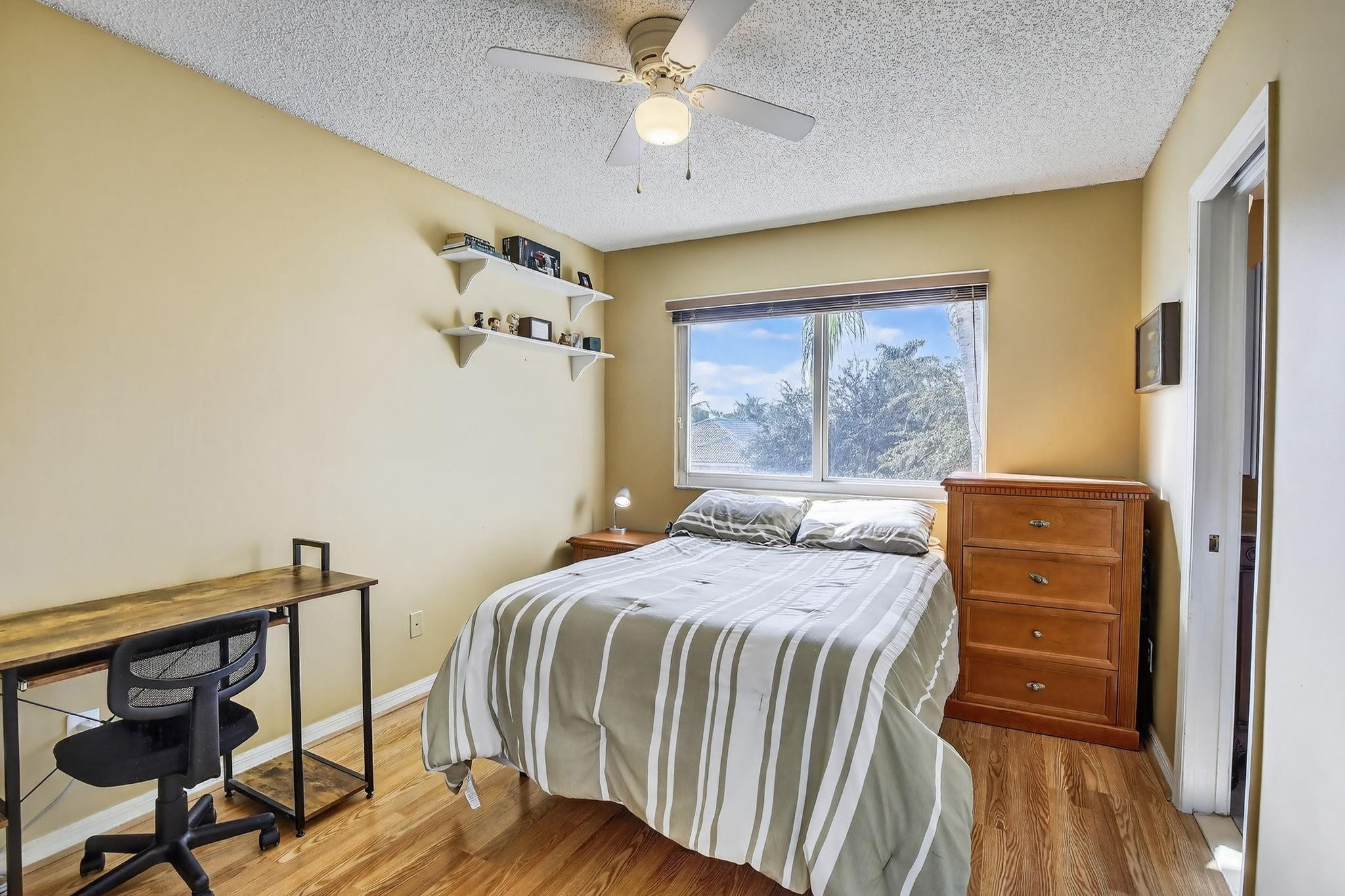 19427 Southwest 65th Street Fort Lauderdale, FL 33332 - Photo 26 of 56 a bedroom with a bed and a chandelier