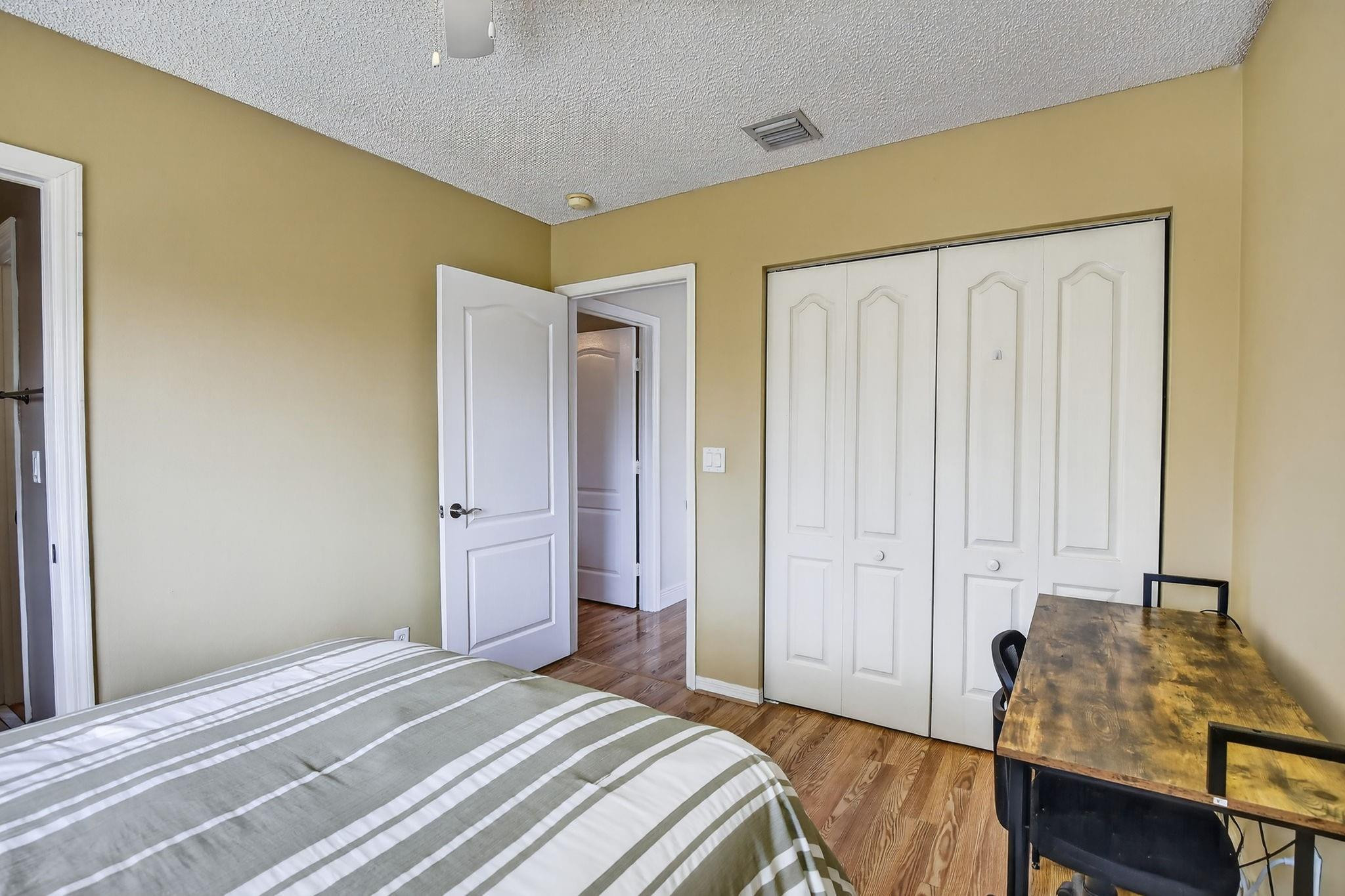 19427 Southwest 65th Street Fort Lauderdale, FL 33332 - Photo 27 of 56 a bedroom with a bed and wooden floor
