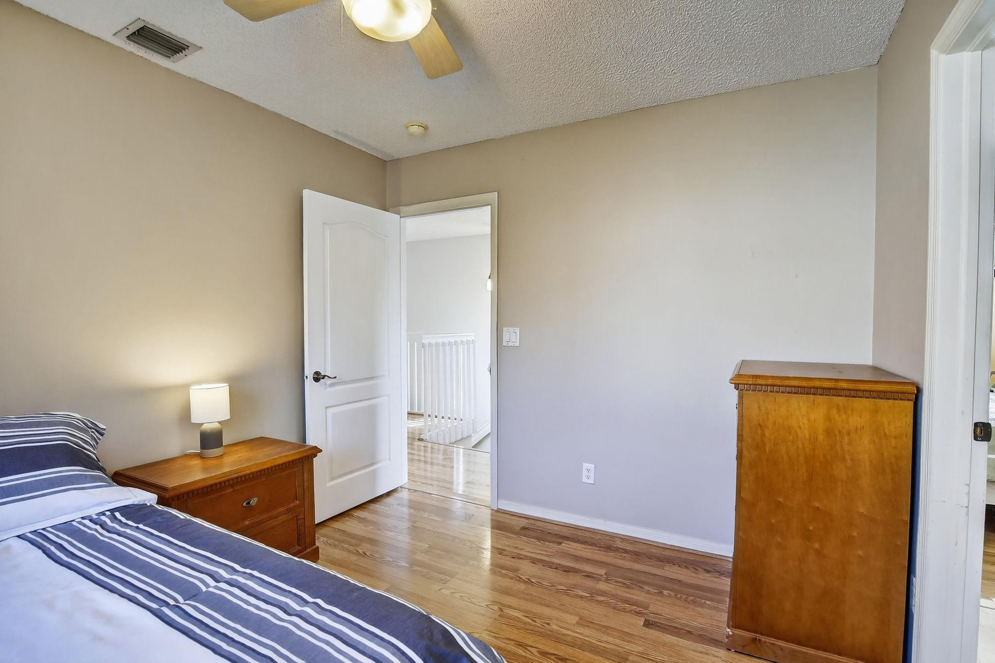 19427 Southwest 65th Street Fort Lauderdale, FL 33332 - Photo 29 of 56 a bedroom with a bed and wooden floor