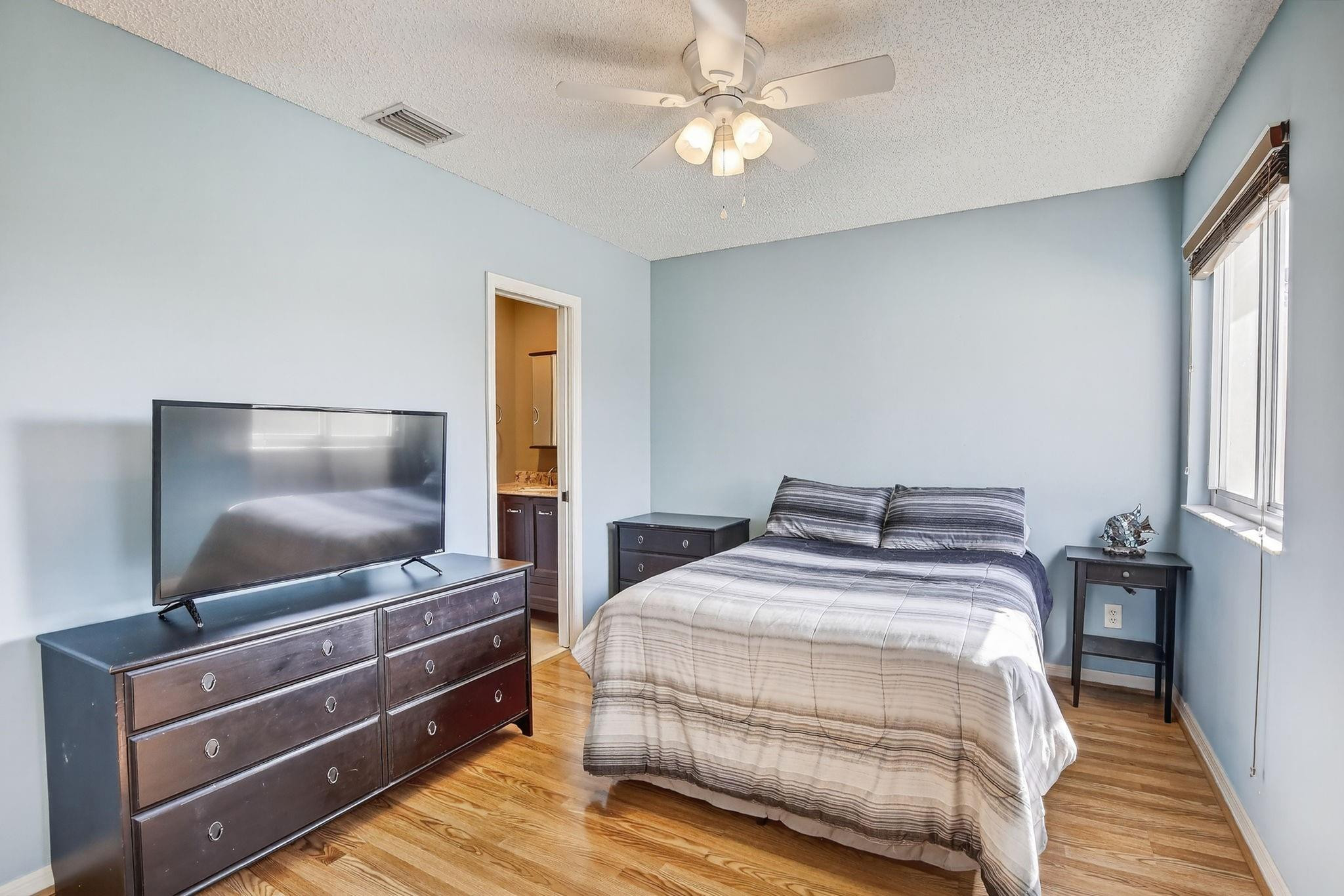 19427 Southwest 65th Street Fort Lauderdale, FL 33332 - Photo 33 of 56 a bedroom with a bed and a flat screen tv