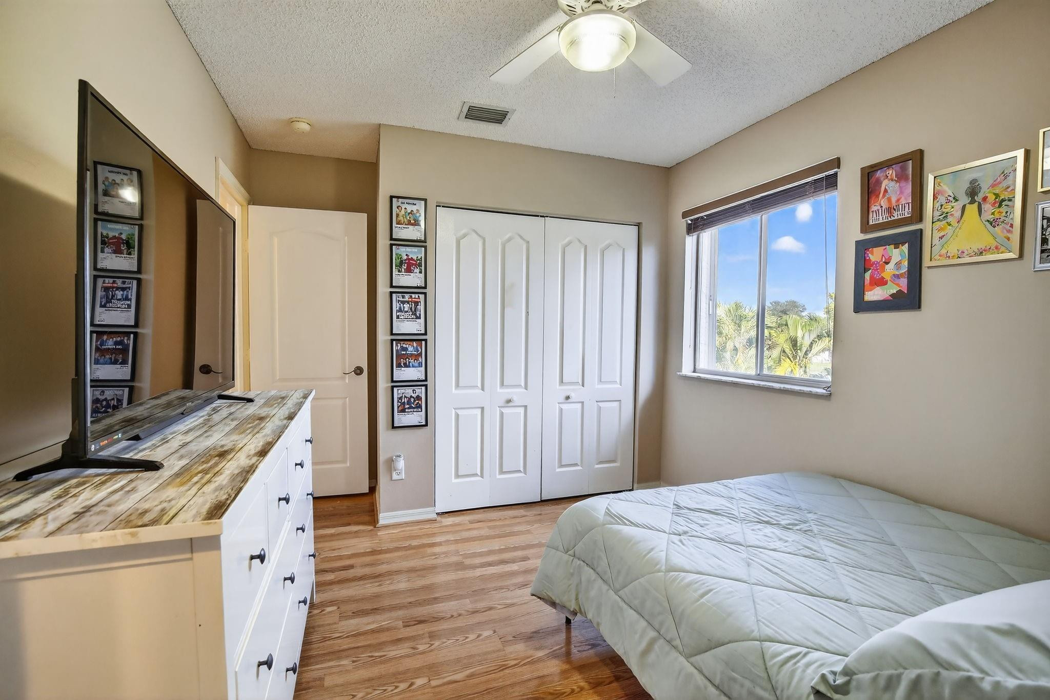 19427 Southwest 65th Street Fort Lauderdale, FL 33332 - Photo 37 of 56 a bedroom with a bed and a chandelier