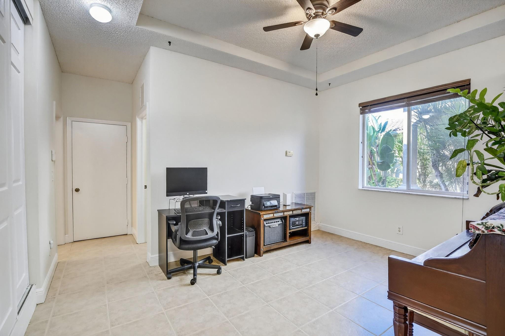 19427 Southwest 65th Street Fort Lauderdale, FL 33332 - Photo 8 of 56 a view of a workspace with furniture and a window