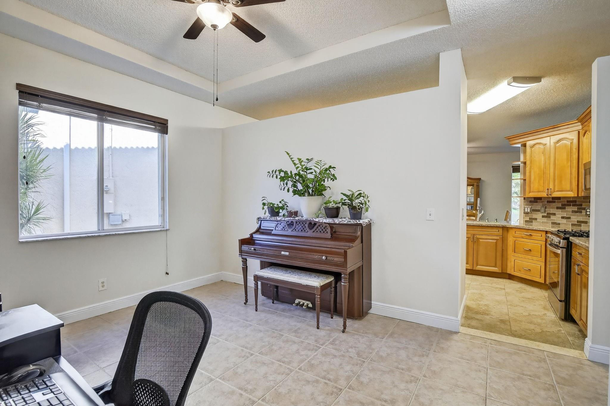 19427 Southwest 65th Street Fort Lauderdale, FL 33332 - Photo 9 of 56 a view of a workspace with furniture and a window