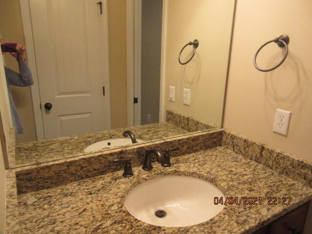4434 Mirada Way Crestview, FL 32539 - Photo 11 of 21 a bathroom with a granite countertop sink and a mirror
