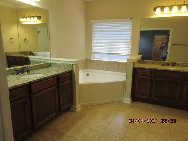 4434 Mirada Way Crestview, FL 32539 - Photo 17 of 21 a bathroom with a granite countertop sink and a mirror