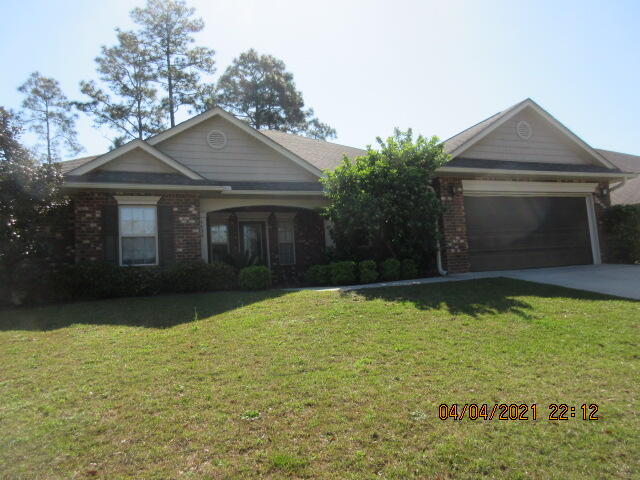 4434 Mirada Way Crestview, FL 32539 - Photo 2 of 21 a front view of a house with garden