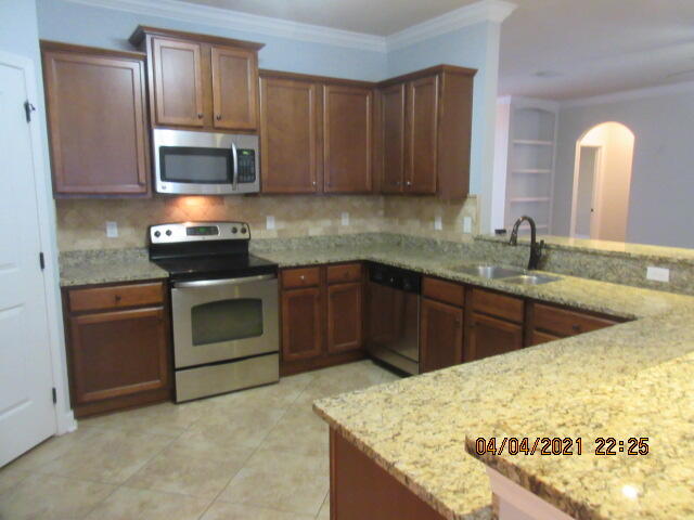 4434 Mirada Way Crestview, FL 32539 - Photo 7 of 21 a kitchen with stainless steel appliances granite countertop a sink stove and microwave