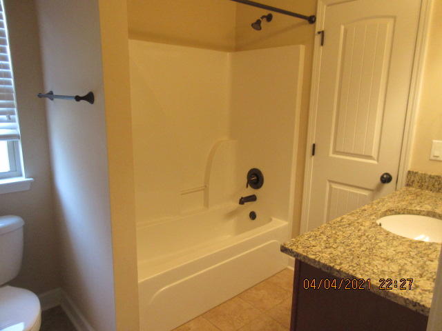 4434 Mirada Way Crestview, FL 32539 - Photo 10 of 21 a bathroom with a granite countertop sink a toilet and shower