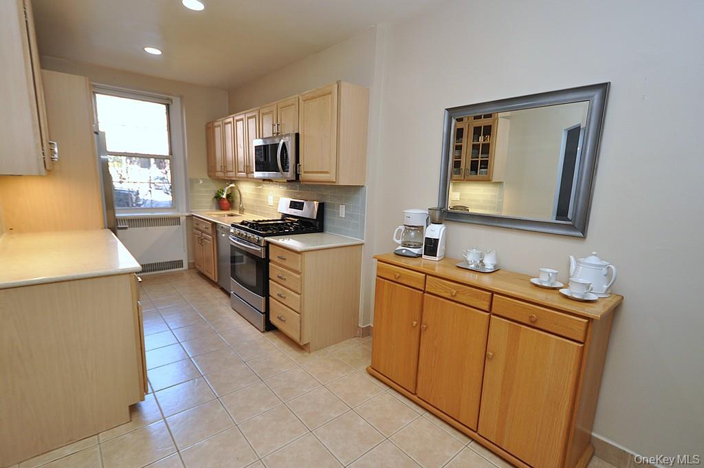 253 Garth Road, Unit 1T Scarsdale, NY 10583 - Photo 13 of 45 a kitchen with cabinets a sink and appliances