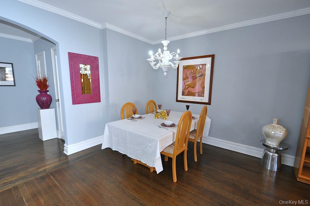 253 Garth Road, Unit 1T Scarsdale, NY 10583 - Photo 18 of 45 a view of a dining room with furniture wooden floor and chandelier