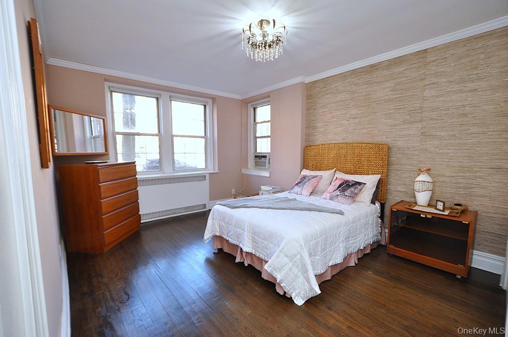 253 Garth Road, Unit 1T Scarsdale, NY 10583 - Photo 20 of 45 a bedroom with a bed and wooden floor