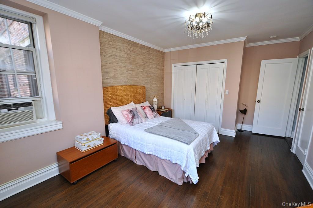 253 Garth Road, Unit 1T Scarsdale, NY 10583 - Photo 21 of 45 a bedroom with a bed and wooden floor