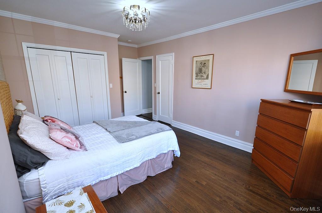 253 Garth Road, Unit 1T Scarsdale, NY 10583 - Photo 23 of 45 a bedroom with a bed and a dresser in it