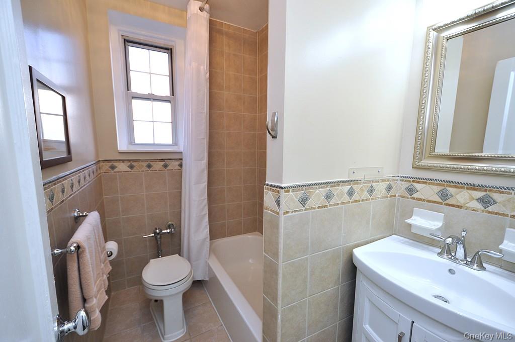 253 Garth Road, Unit 1T Scarsdale, NY 10583 - Photo 24 of 45 a bathroom with a sink a toilet and shower